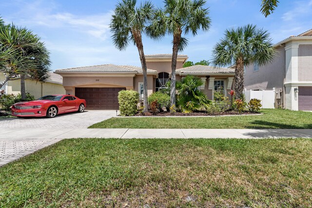 2111 Bellcrest Ct, Royal Palm Beach, FL 33411 - view of front of home with an attached garage, decorative driveway, a tiled roof, and stucco siding