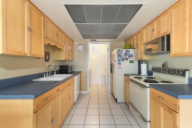 431 Jupiter Lakes Blvd Unit 2113C, Jupiter, FL 33458 - kitchen featuring light brown cabinetry, dark countertops, white appliances, a sink, and light tile patterned floors