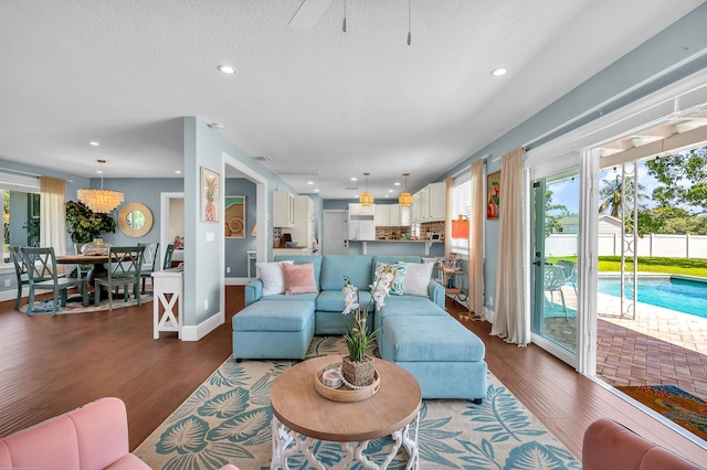 living room featuring recessed lighting, wood finished floors, visible vents, baseboards, and ceiling fan