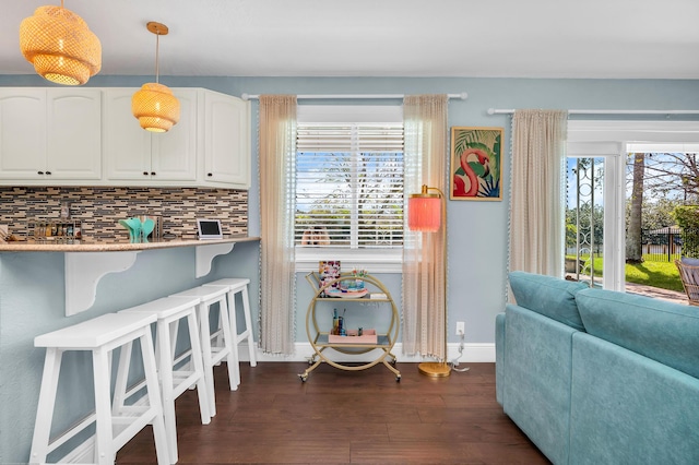 kitchen featuring butcher block counters, white appliances, glass insert cabinets, and tasteful backsplash