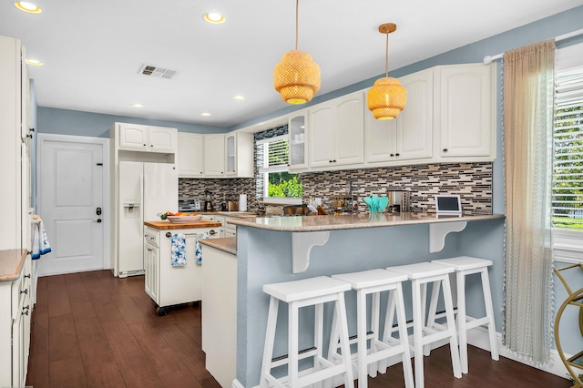 kitchen with wooden counters, white appliances, dark wood-style flooring, visible vents, and recessed lighting