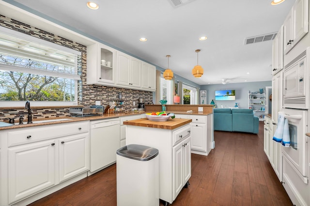 kitchen featuring tasteful backsplash, white appliances, glass insert cabinets, white cabinets, and visible vents