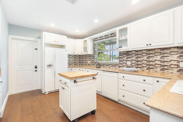 kitchen featuring butcher block countertops, white cabinetry, dark wood-style flooring, and white appliances