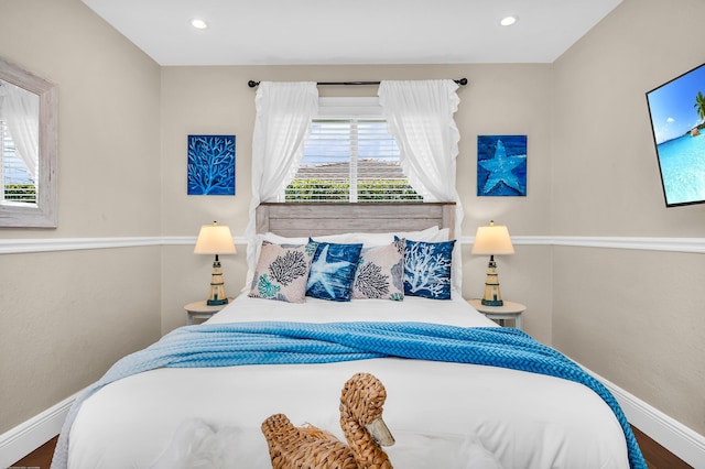interior space with wood finished floors and baseboards