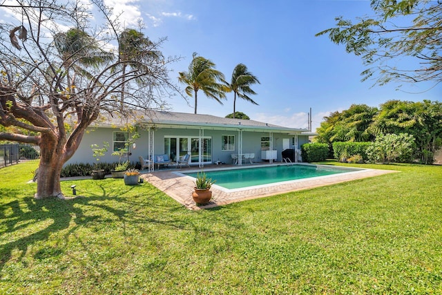 back of house featuring fence, an outdoor pool, a yard, and a patio area
