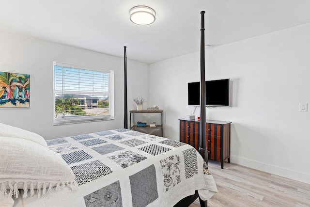 bedroom with baseboards and light wood-type flooring