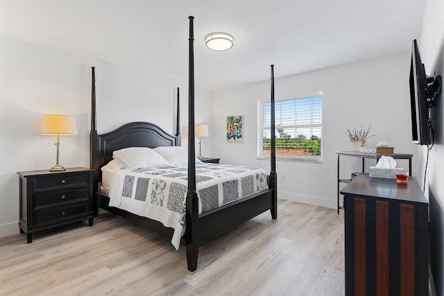 bedroom featuring baseboards and light wood-style flooring