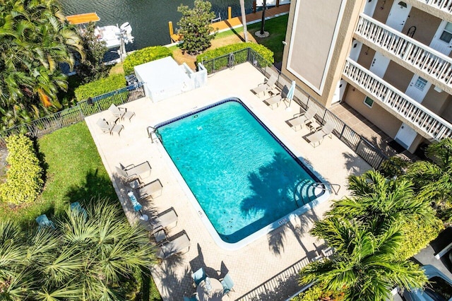 pool with a patio and fence