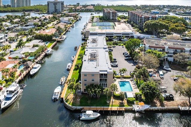 drone / aerial view featuring a city view and a water view