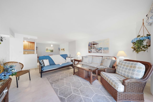 living room featuring light tile patterned flooring and visible vents