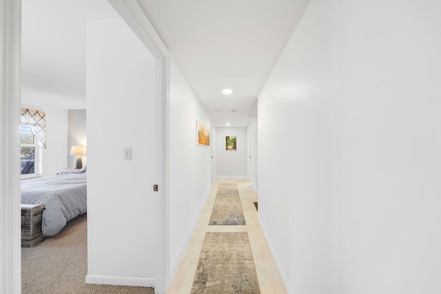hallway with baseboards and recessed lighting