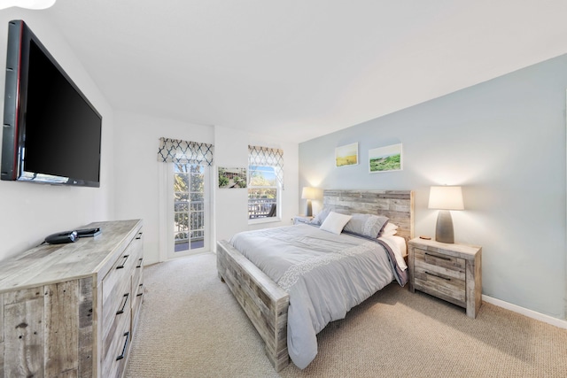 bedroom featuring access to outside and light carpet