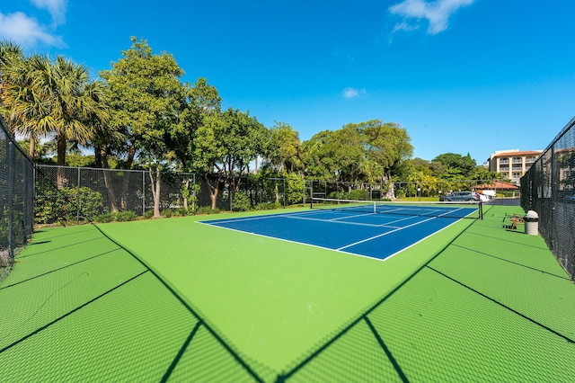 view of tennis court featuring fence and community basketball court