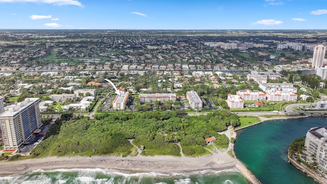 drone / aerial view with a view of city, a water view, and a view of the beach
