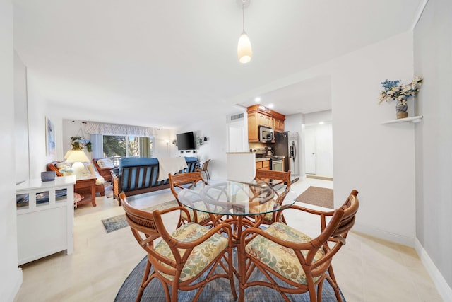 dining room with visible vents and baseboards