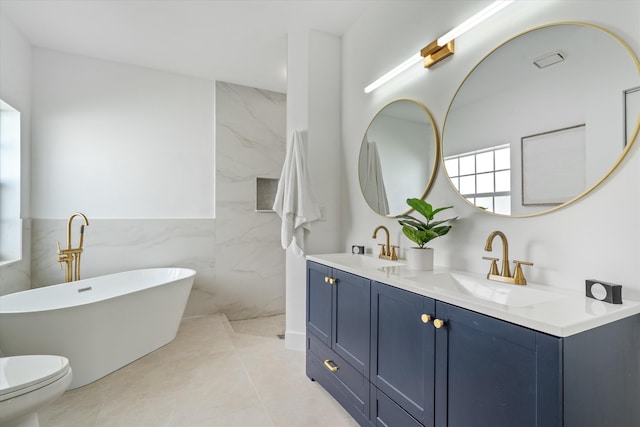 bathroom featuring double vanity, a sink, a freestanding bath, and tile walls
