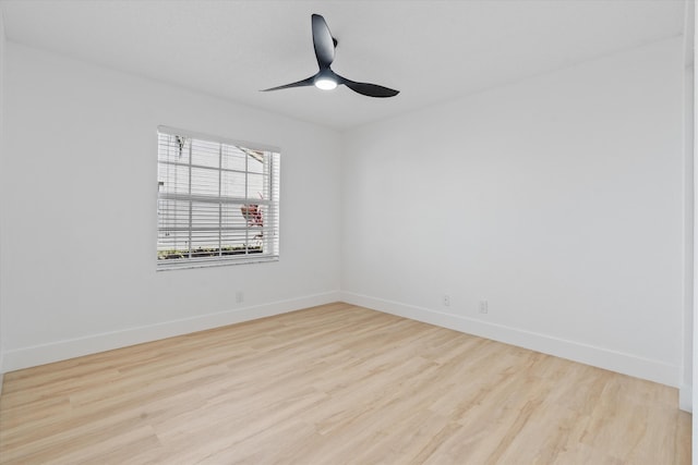 empty room with baseboards, ceiling fan, and wood finished floors