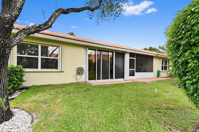 6092 Caladium Rd, Delray Beach, FL 33484 - back of property with stucco siding, a yard, and a tile roof
