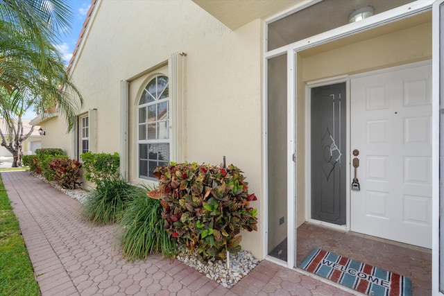 entrance to property featuring stucco siding