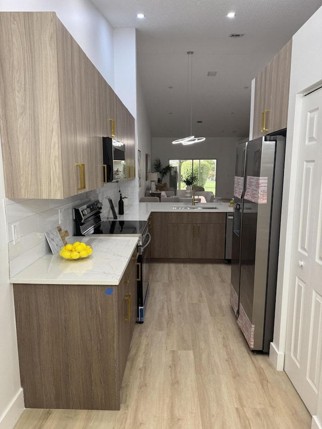 6092 Caladium Rd, Delray Beach, FL 33484 - kitchen with black range with electric stovetop, stainless steel refrigerator with ice dispenser, modern cabinets, and tasteful backsplash