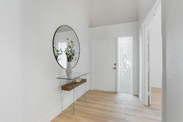 entryway featuring baseboards and light wood finished floors