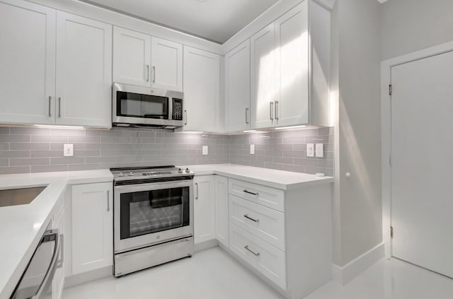 kitchen featuring light countertops, stainless steel appliances, white cabinetry, and tasteful backsplash