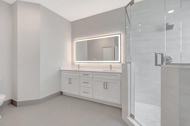 full bath with double vanity, a sink, a stall shower, and toilet