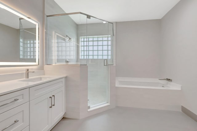 full bathroom featuring vanity, a bath, and a stall shower