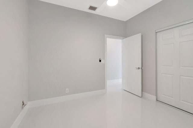 unfurnished bedroom with ceiling fan, a closet, and visible vents
