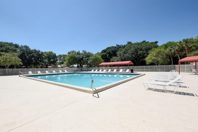 pool featuring a gazebo, fence, and a patio area