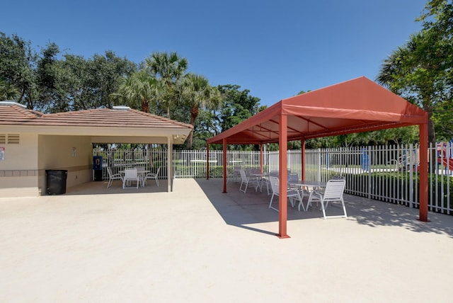 surrounding community featuring fence, a gazebo, and a patio area