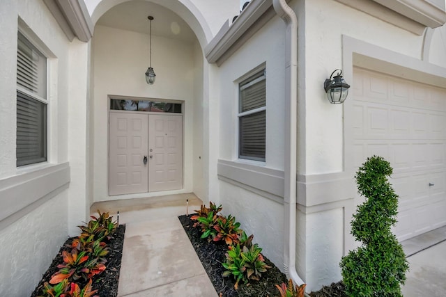 entrance to property featuring stucco siding
