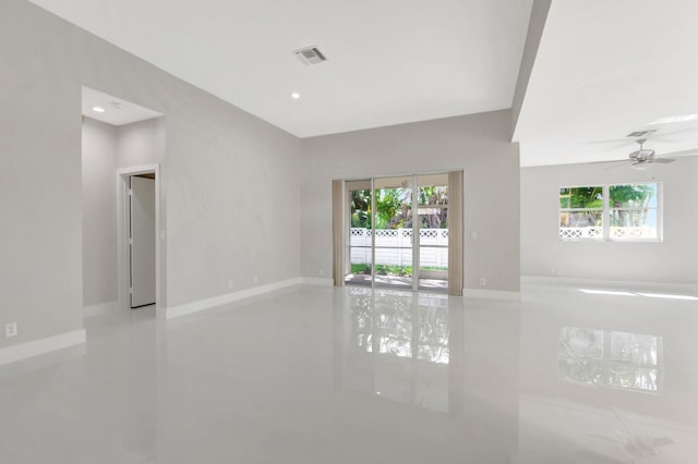 spare room with baseboards, visible vents, and a wealth of natural light