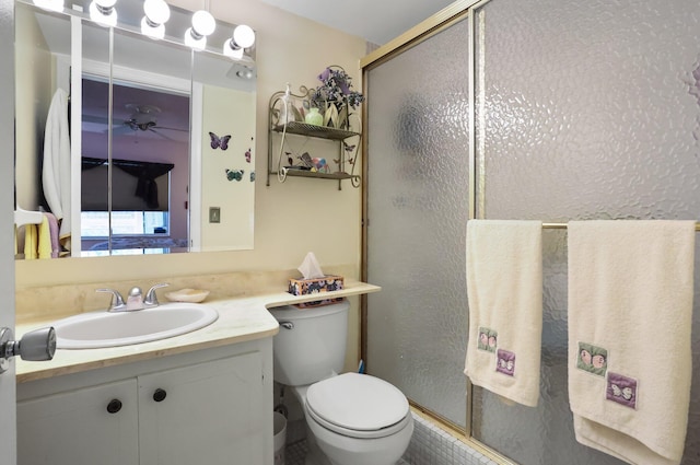 full bath with a shower stall, vanity, and toilet