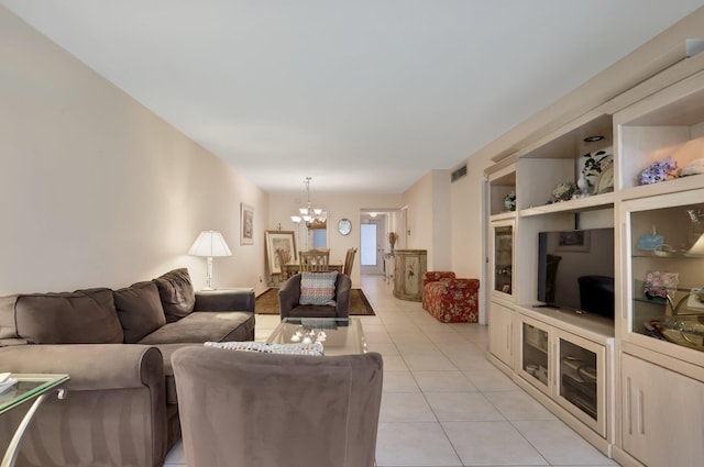 living area with visible vents, an inviting chandelier, and light tile patterned floors