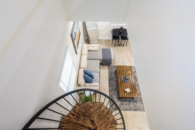 staircase with baseboards and wood finished floors