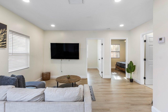 living area with recessed lighting, light wood-style floors, baseboards, and visible vents