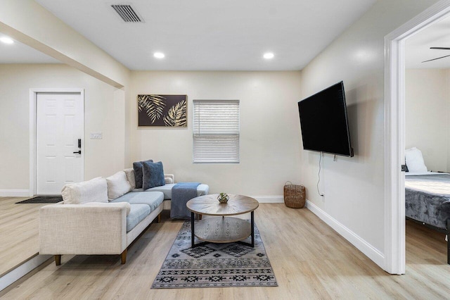 living area featuring visible vents, baseboards, recessed lighting, and wood finished floors
