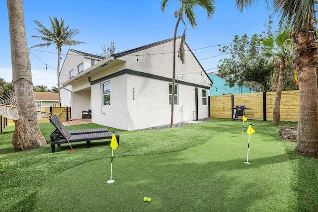 exterior space with fence and stucco siding
