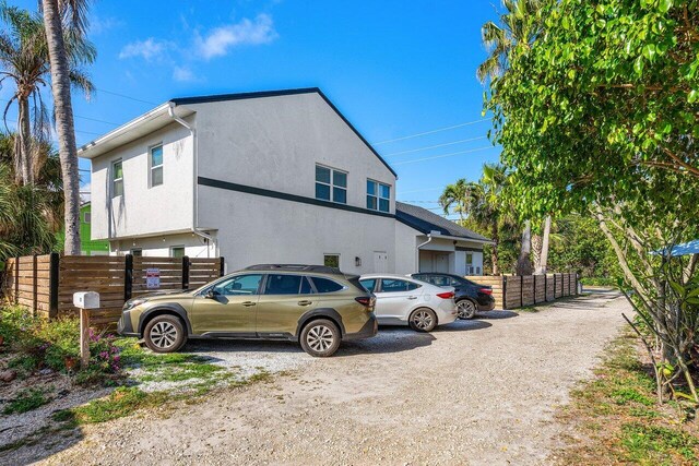 view of front of property featuring fence and stucco siding