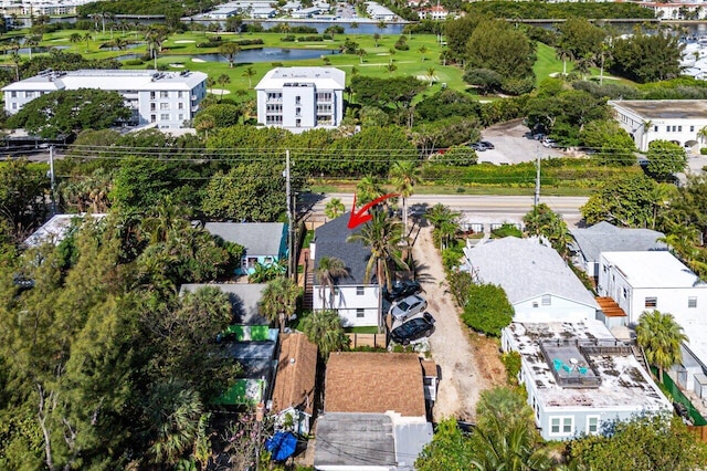 bird's eye view with a water view, view of golf course, and a residential view