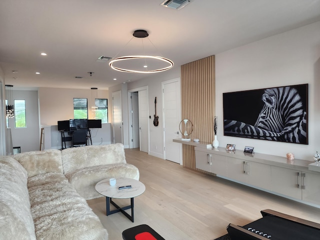 living area featuring wood finished floors, visible vents, and recessed lighting