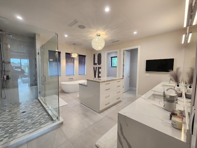 bathroom with a shower stall, a freestanding tub, visible vents, recessed lighting, and double vanity
