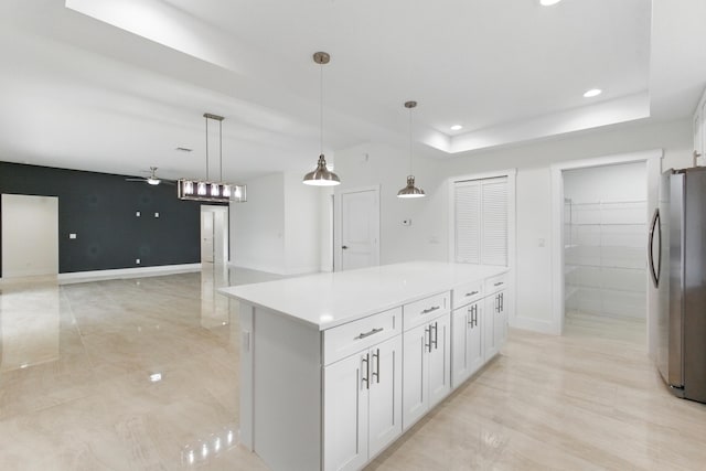 6002 Myrtle Dr, Fort Pierce, FL 34982 - kitchen with freestanding refrigerator, ceiling fan, white cabinetry, a kitchen island, and pendant lighting