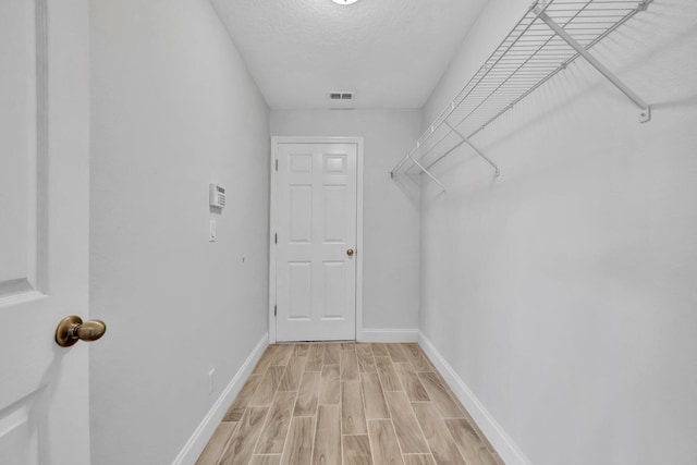 698 SW Mchole Ave, Port Saint Lucie, FL 34953 - spacious closet featuring light wood-type flooring and visible vents