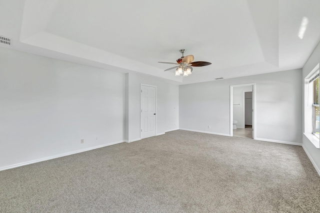 698 SW Mchole Ave, Port Saint Lucie, FL 34953 - empty room with ceiling fan, carpet floors, and a raised ceiling