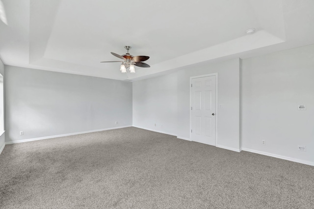 698 SW Mchole Ave, Port Saint Lucie, FL 34953 - carpeted spare room featuring a raised ceiling, a ceiling fan, and baseboards
