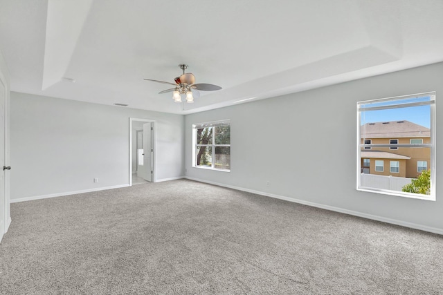 698 SW Mchole Ave, Port Saint Lucie, FL 34953 - carpeted spare room with baseboards, a ceiling fan, visible vents, and a raised ceiling