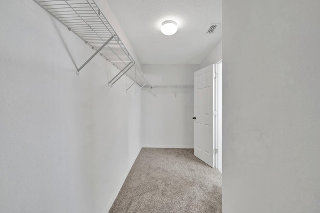 698 SW Mchole Ave, Port Saint Lucie, FL 34953 - walk in closet featuring visible vents and carpet flooring