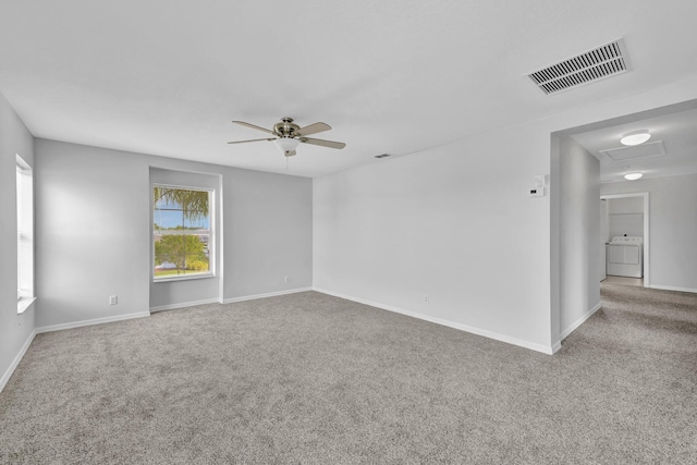 698 SW Mchole Ave, Port Saint Lucie, FL 34953 - unfurnished room featuring visible vents, carpet, ceiling fan, and washer / dryer